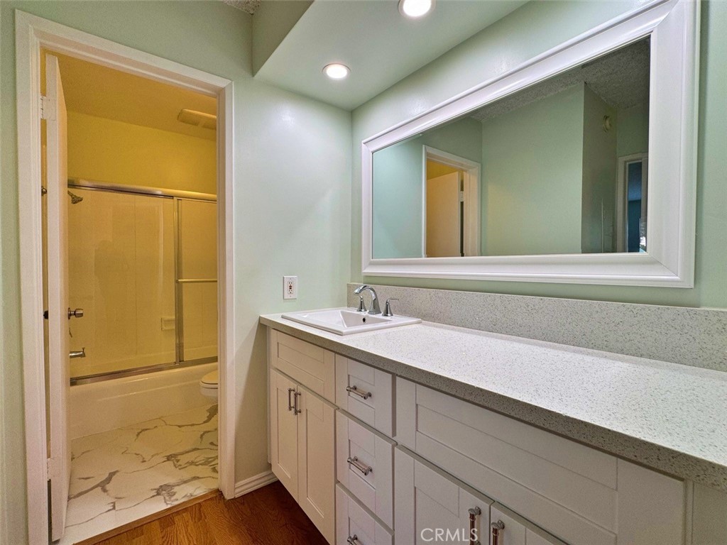 5625 North Sumner Way, Unit 212 Culver City, CA 90230 - Photo 31 of 39 a bathroom with a granite countertop sink and a mirror
