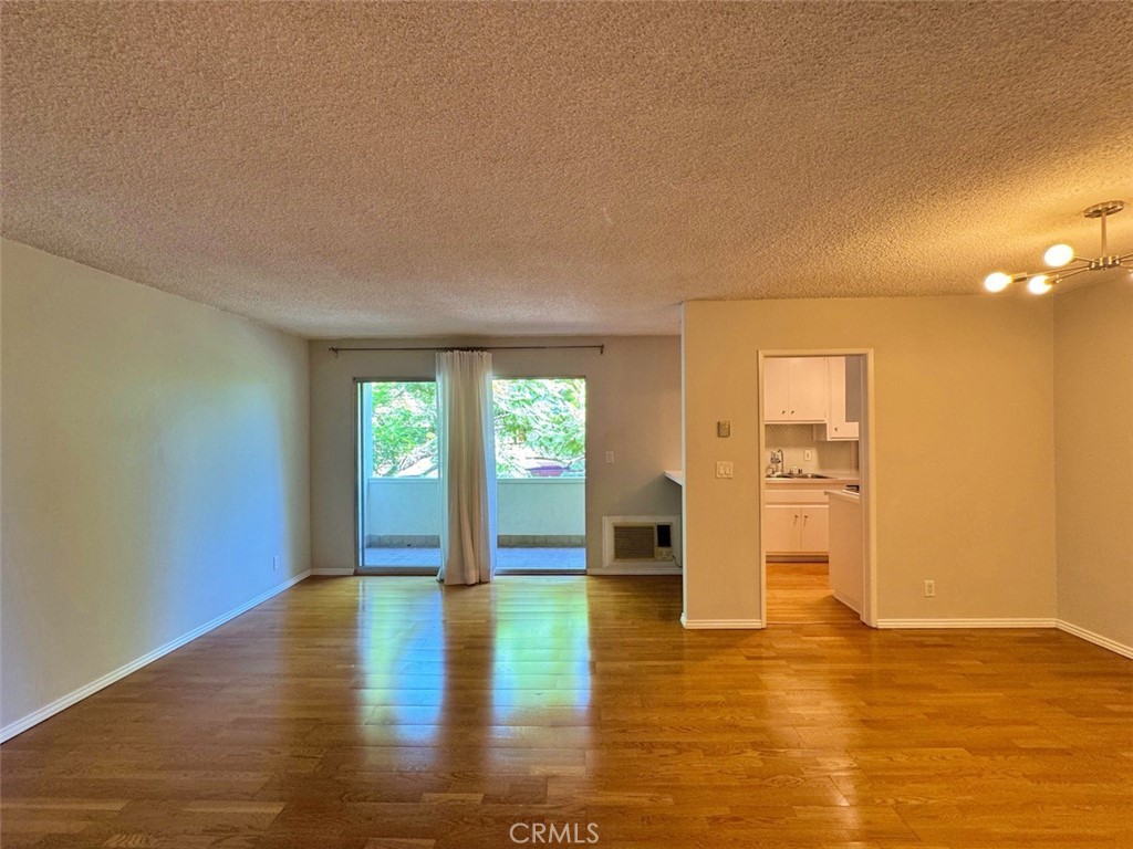 5625 North Sumner Way, Unit 212 Culver City, CA 90230 - Photo 7 of 39 a view of empty room with wooden floor and fan