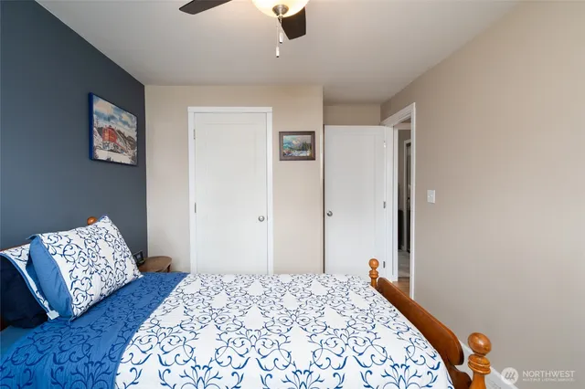 a bedroom with bed and wooden floor