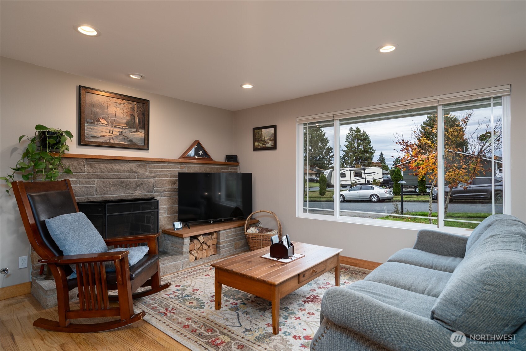 2304 E Avenue Anacortes, WA 98221 - Photo 6 of 26 a living room with furniture a fireplace and a flat screen tv