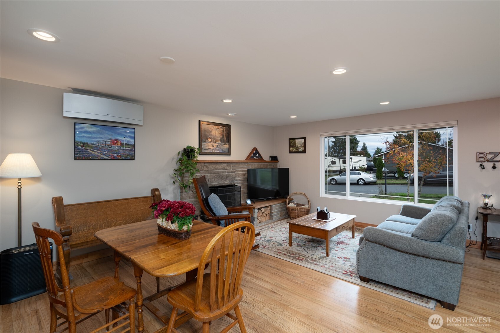 2304 E Avenue Anacortes, WA 98221 - Photo 7 of 26 a living room with furniture a fireplace and a floor to ceiling window