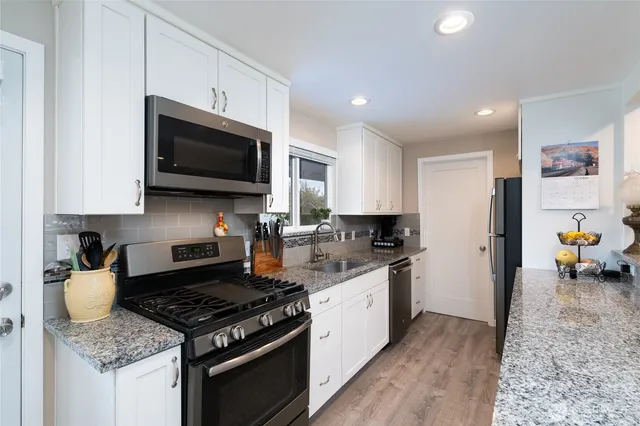 a kitchen with a stove microwave and sink