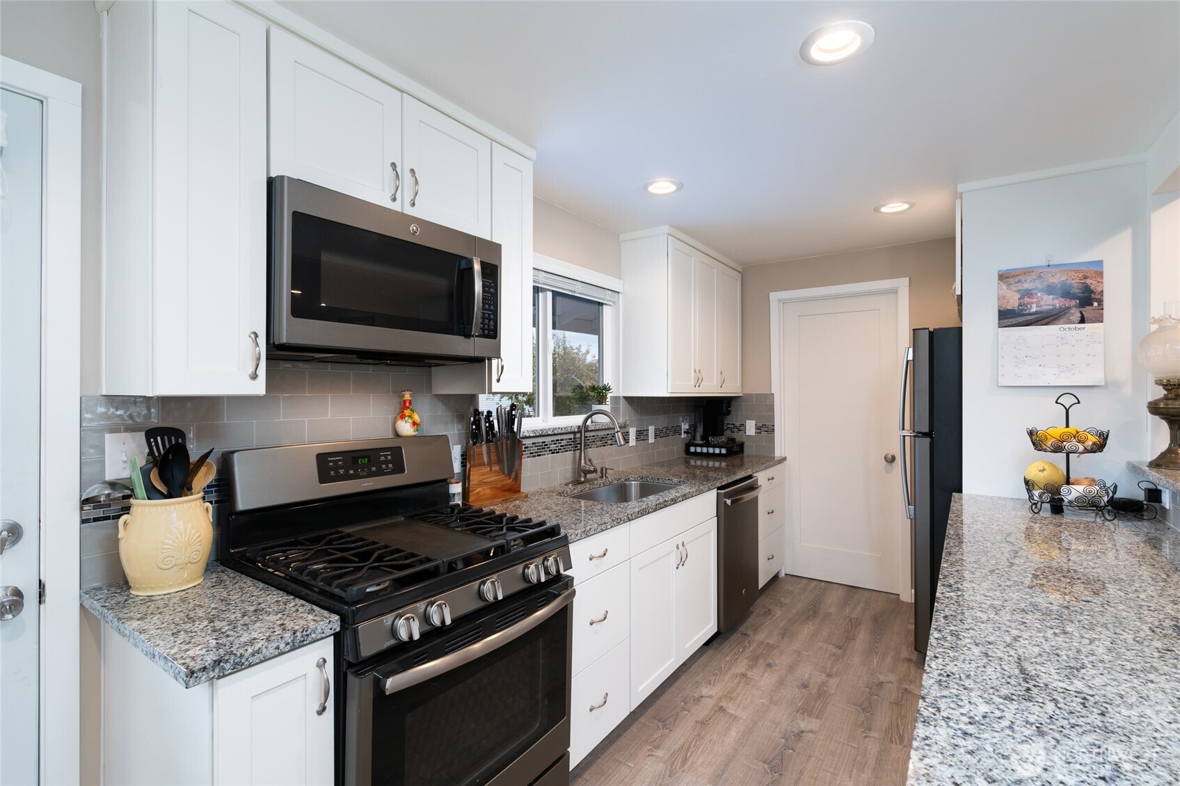 2304 E Avenue Anacortes, WA 98221 - Photo 9 of 26 a kitchen with a stove microwave and sink