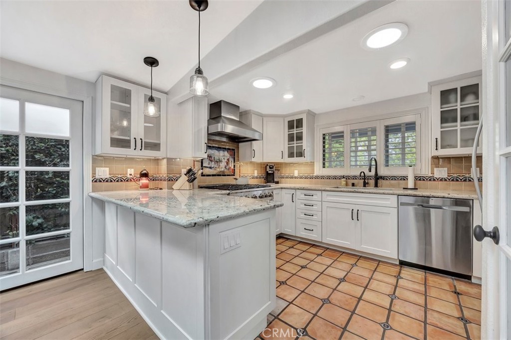 306 Avenida Monterey San Clemente, CA 92672 - Photo 15 of 41 a kitchen with stainless steel appliances kitchen island granite countertop a sink and cabinets