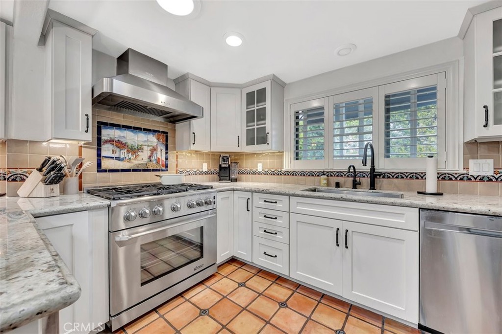 306 Avenida Monterey San Clemente, CA 92672 - Photo 16 of 41 a kitchen with granite countertop white cabinets stainless steel appliances and a sink