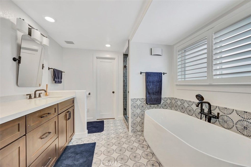 306 Avenida Monterey San Clemente, CA 92672 - Photo 24 of 41 a bathroom with a tub sink and mirror