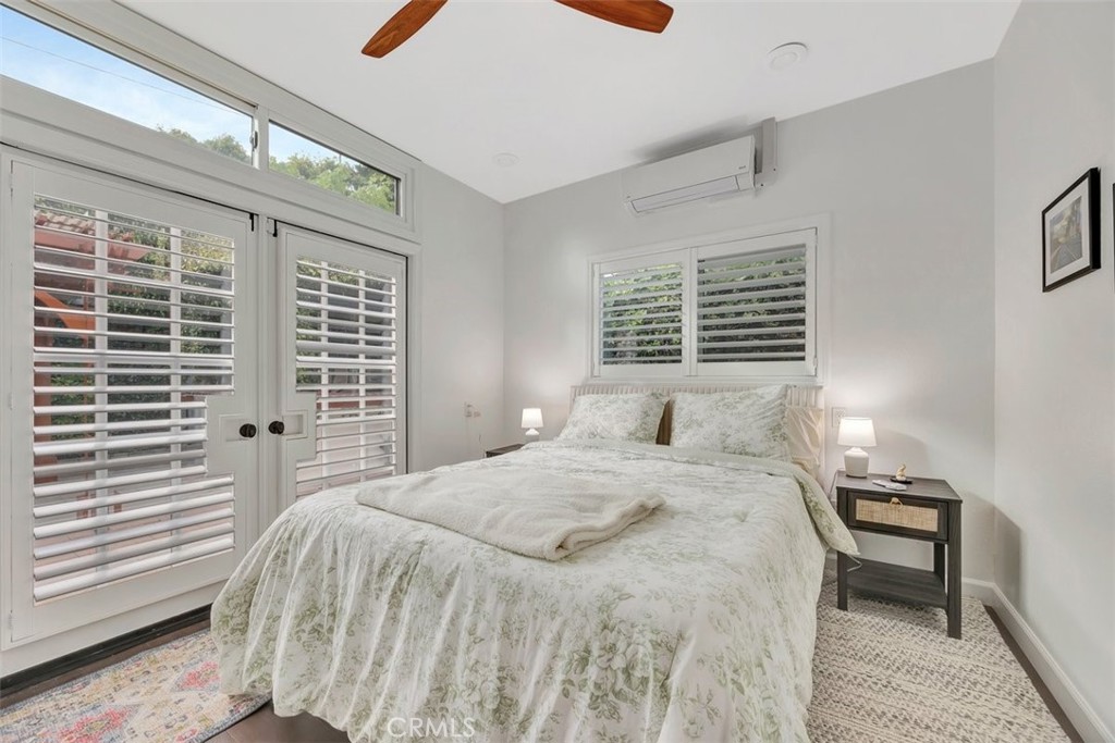 306 Avenida Monterey San Clemente, CA 92672 - Photo 27 of 41 a bedroom with a bed next to a window and a flat tv screen