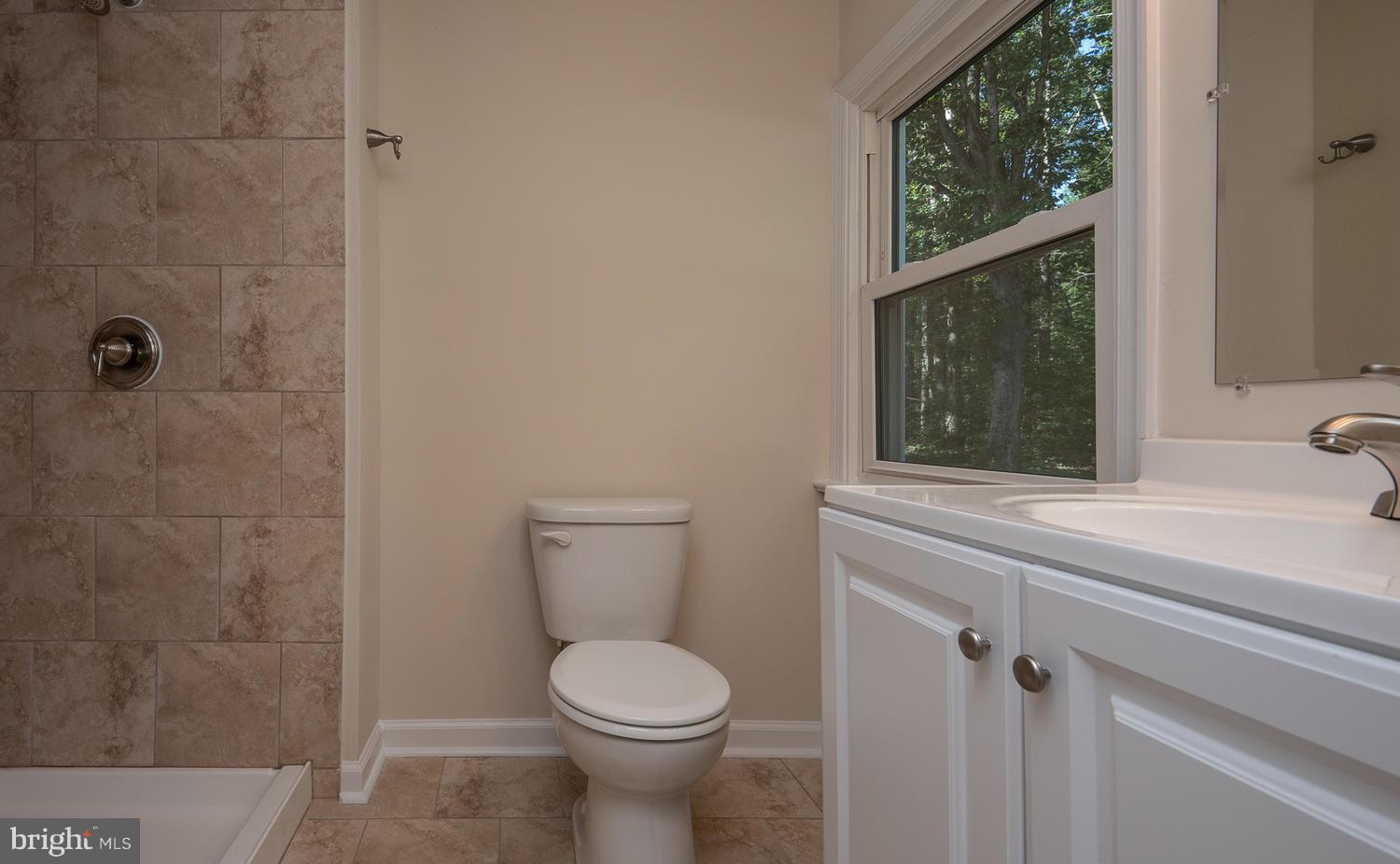 3116 Lewiston Road Bumpass, VA 23024 - Photo 15 of 27 a bathroom with a toilet a sink and a shower