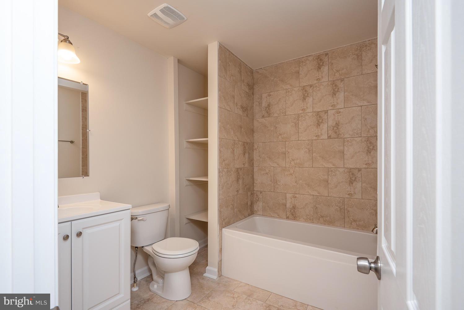 3116 Lewiston Road Bumpass, VA 23024 - Photo 21 of 27 a bathroom with a toilet and a bathtub