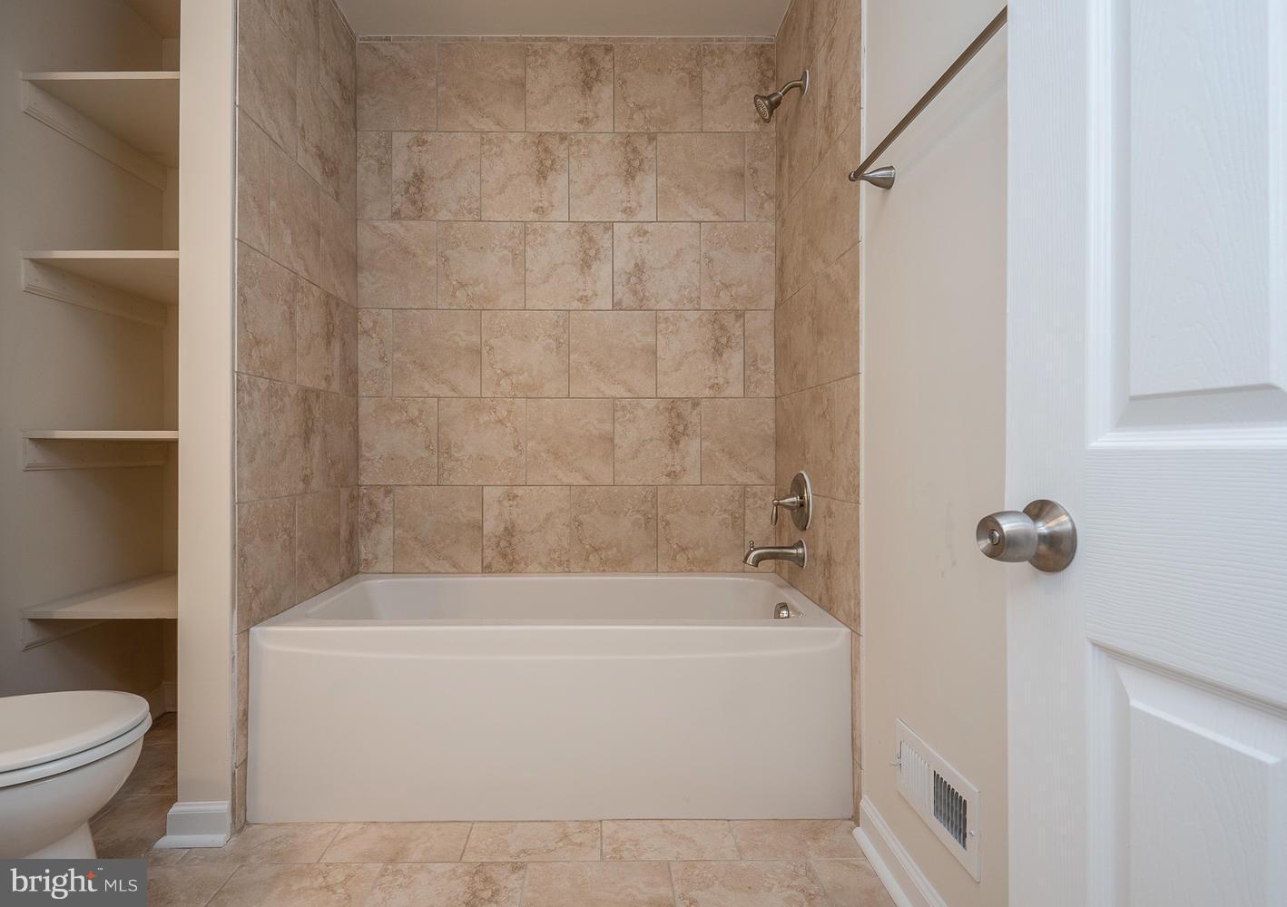 3116 Lewiston Road Bumpass, VA 23024 - Photo 22 of 27 a white bath tub sitting next to a toilet
