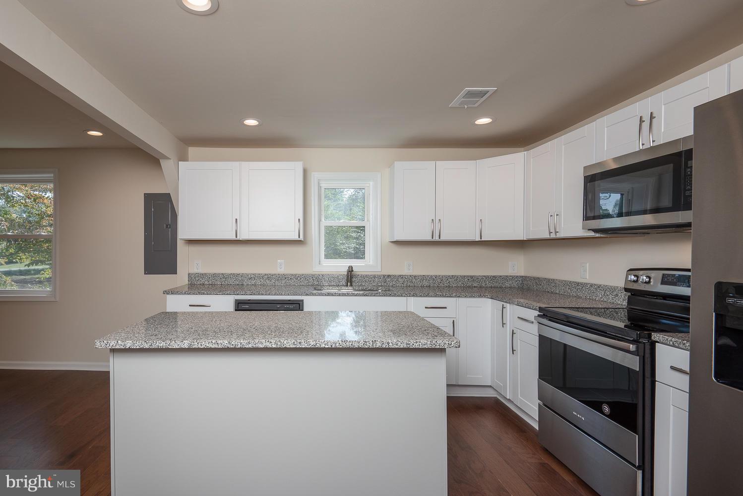 3116 Lewiston Road Bumpass, VA 23024 - Photo 5 of 27 a kitchen with stainless steel appliances granite countertop a stove a sink and a microwave