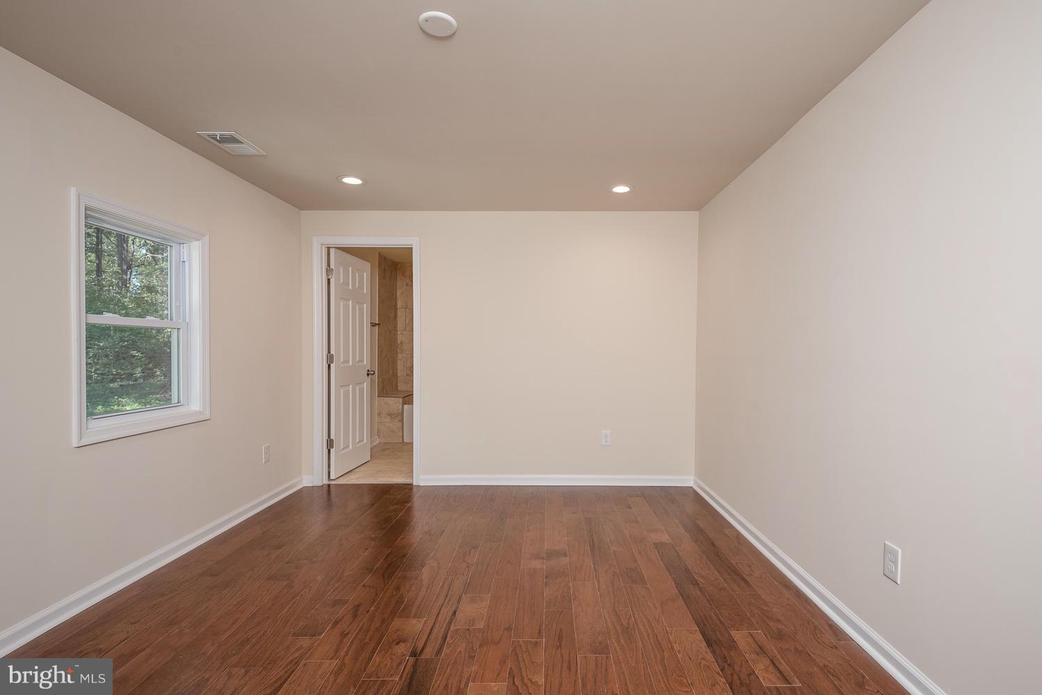 3116 Lewiston Road Bumpass, VA 23024 - Photo 10 of 27 an empty room with wooden floor and windows