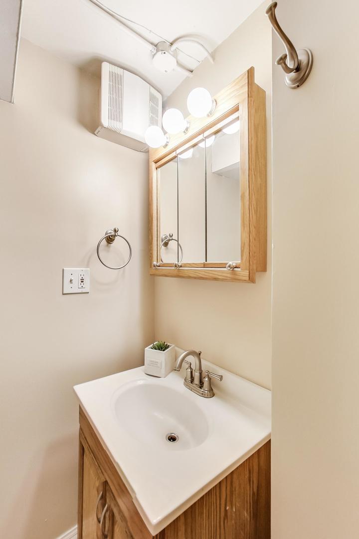 6522 28th Street Berwyn, IL 60402 - Photo 14 of 45 a bathroom with a sink and a mirror