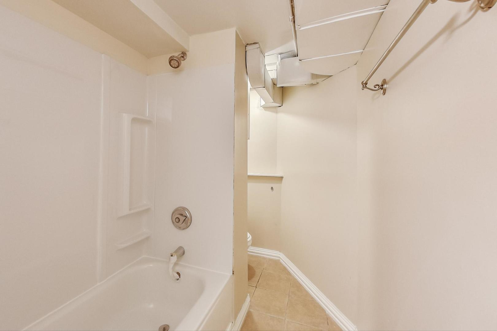 6522 28th Street Berwyn, IL 60402 - Photo 15 of 45 a bathroom with a bathtub and shower