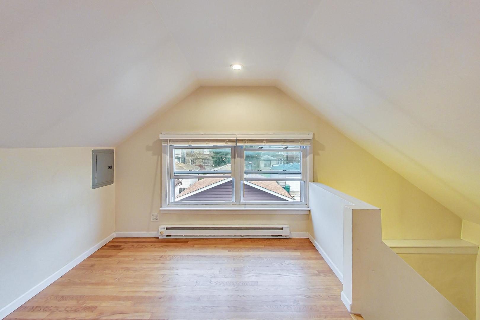 6522 28th Street Berwyn, IL 60402 - Photo 17 of 45 an empty room with wooden floor and windows