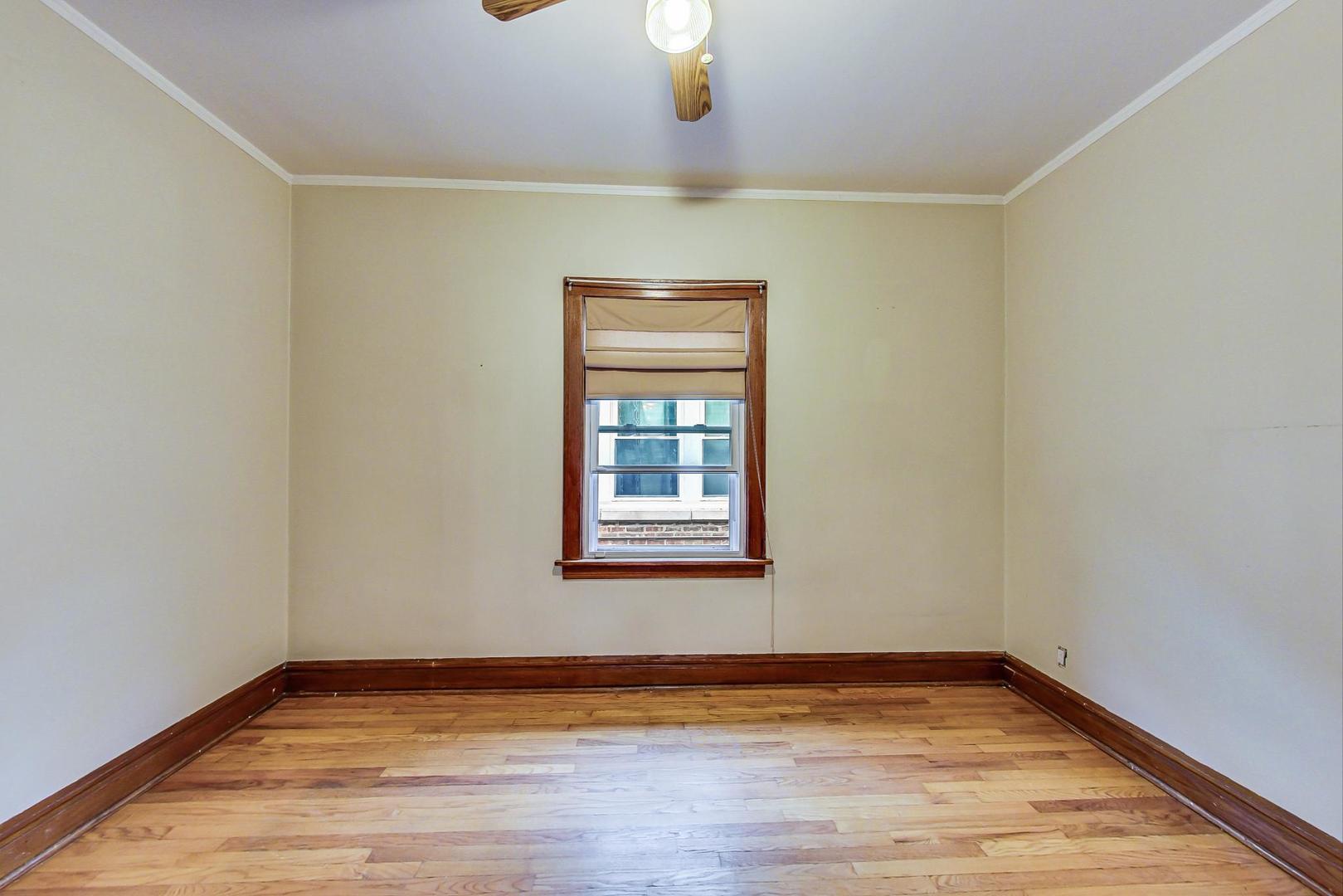 6522 28th Street Berwyn, IL 60402 - Photo 22 of 45 a view of an empty room with wooden floor and a window