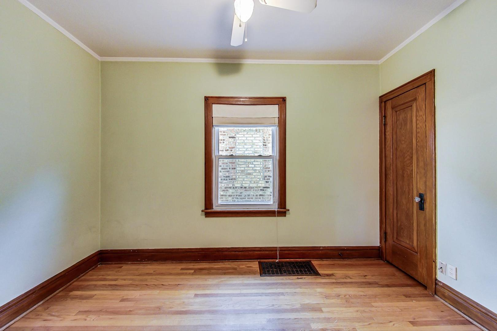 6522 28th Street Berwyn, IL 60402 - Photo 25 of 45 an empty room with wooden floor and window