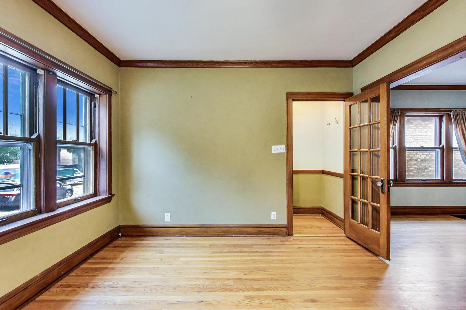 6522 28th Street Berwyn, IL 60402 - Photo 5 of 45 a view of an empty room with a window and wooden floor