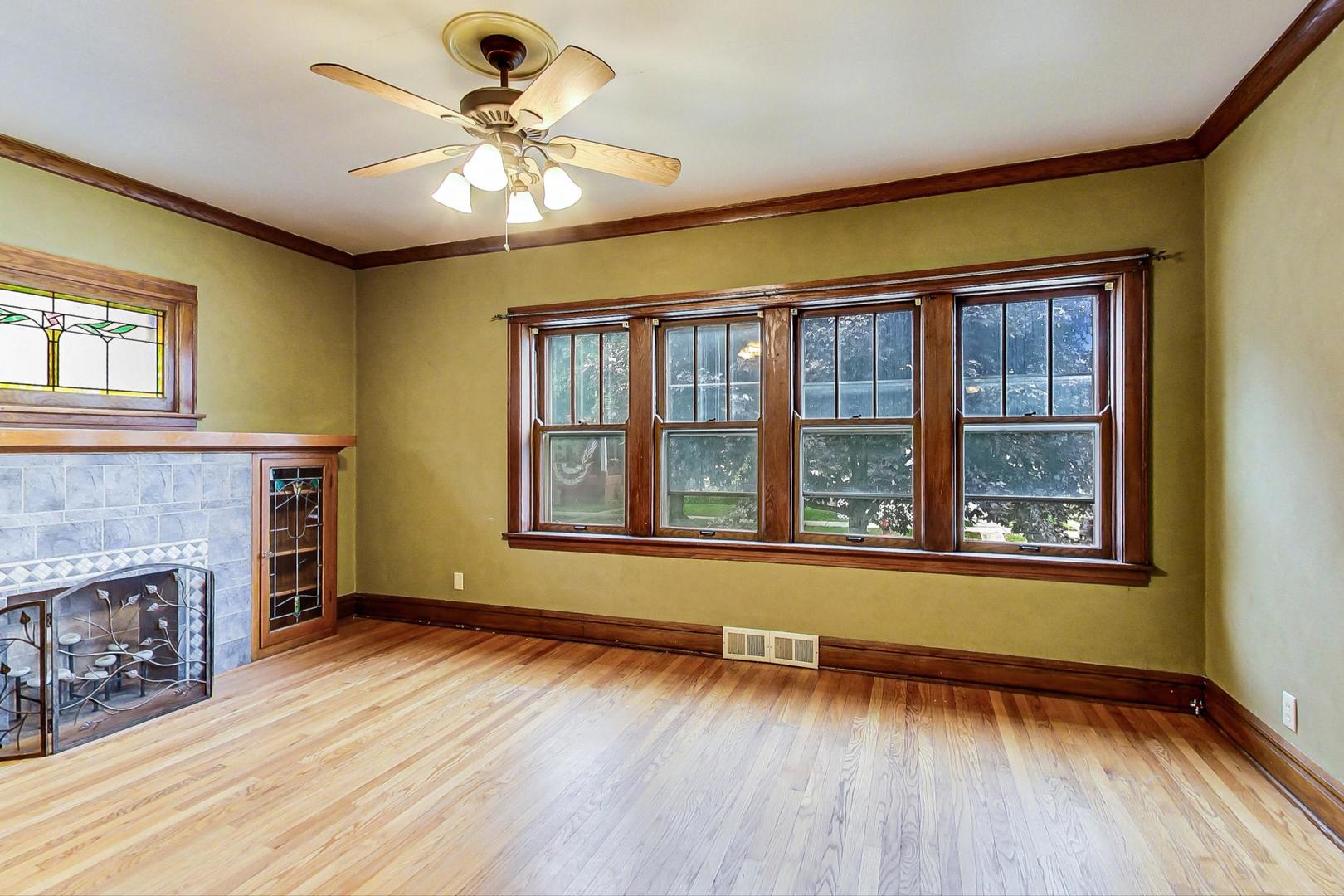 6522 28th Street Berwyn, IL 60402 - Photo 6 of 45 a view of an empty room with wooden floor and a window