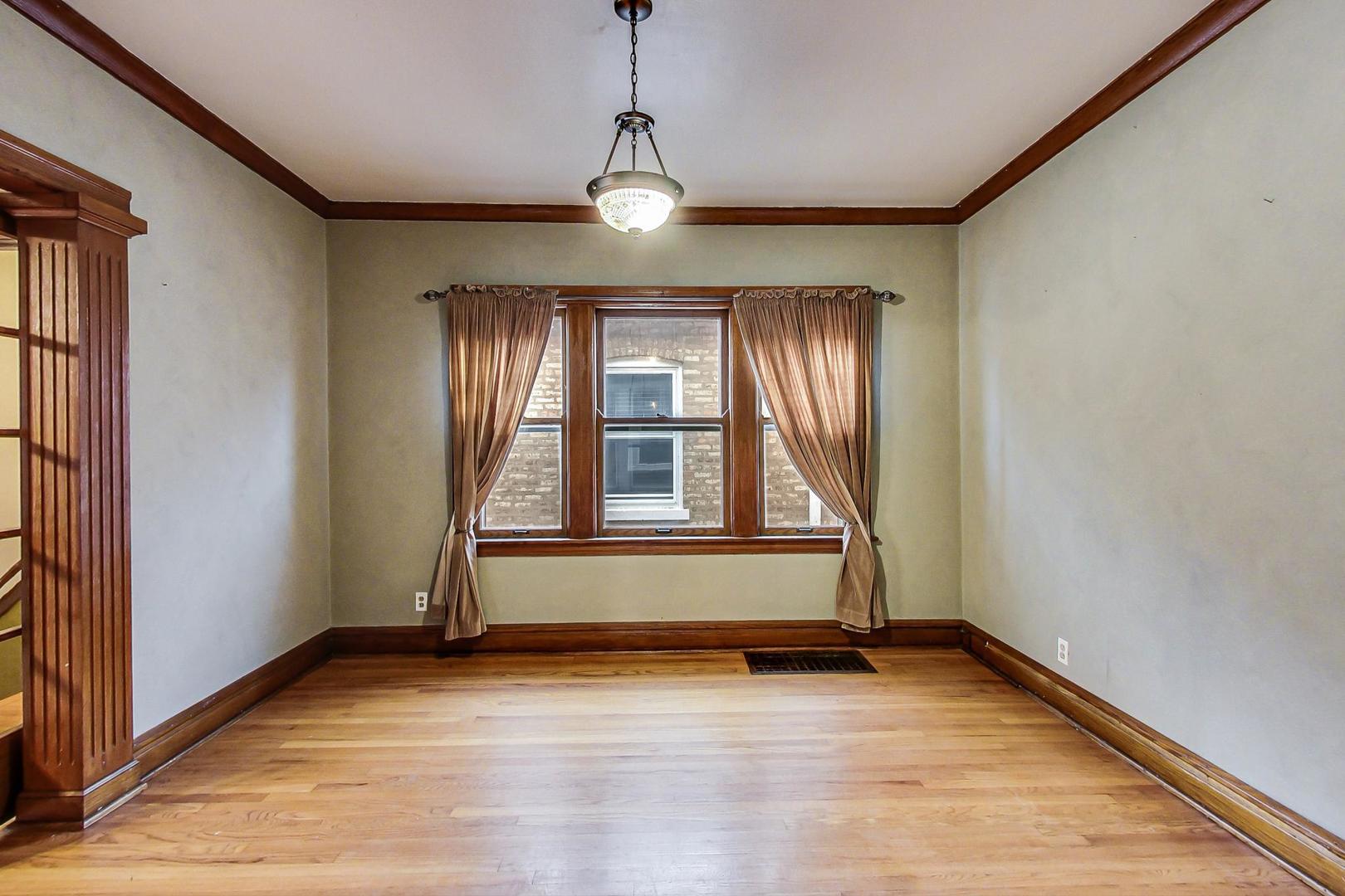 6522 28th Street Berwyn, IL 60402 - Photo 8 of 45 a view of an empty room with wooden floor and a window
