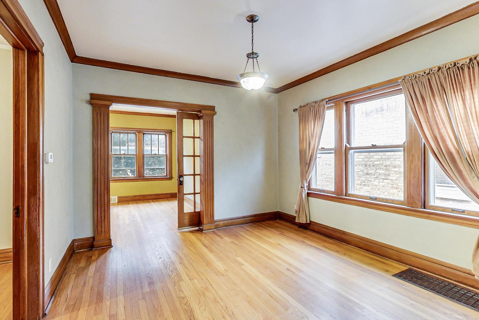 6522 28th Street Berwyn, IL 60402 - Photo 9 of 45 an empty room with wooden floor and windows