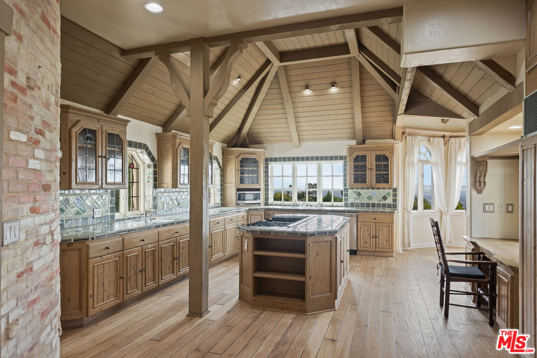 1041 Somera Road Los Angeles, CA 90077 - Photo 14 of 40 a kitchen with stainless steel appliances granite countertop a stove and cabinets