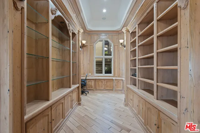 a view of an empty room with a fireplace and a window