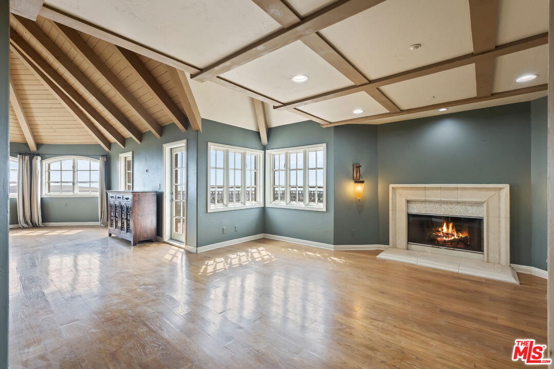 1041 Somera Road Los Angeles, CA 90077 - Photo 18 of 40 a view of an empty room with a fireplace and a window