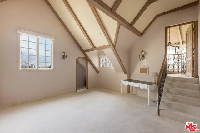 a bathroom with a granite countertop sink a mirror a bathtub and shower