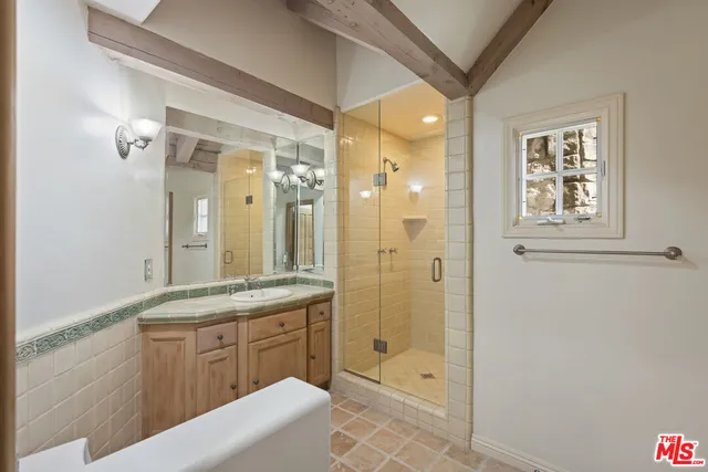 a living room with furniture a fireplace and large windows