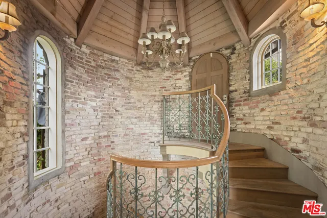 a living room with furniture a fireplace and a large window
