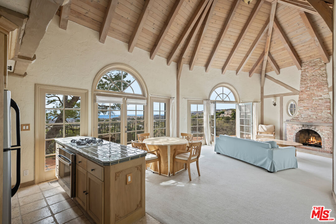 1041 Somera Road Los Angeles, CA 90077 - Photo 29 of 40 a living room with furniture a fireplace and large windows