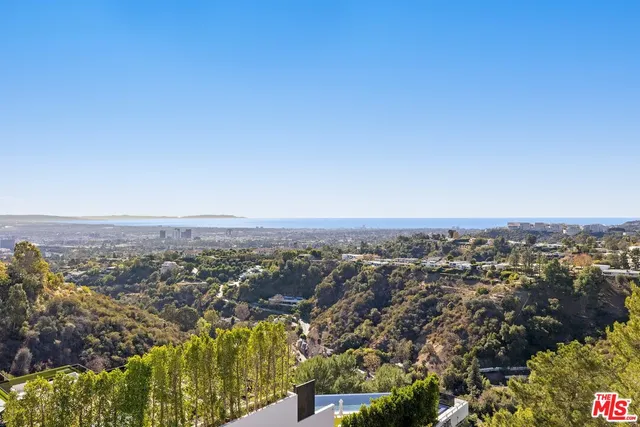 an aerial view of residential houses with city view