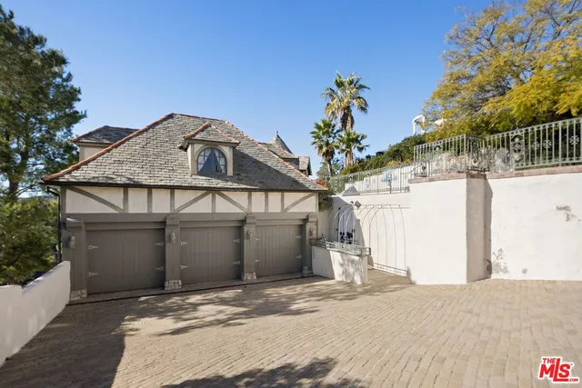 an aerial view of residential house with outdoor space and swimming pool