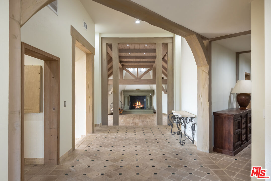 1041 Somera Road Los Angeles, CA 90077 - Photo 7 of 40 a view of a hallway view with wooden floor and a fireplace
