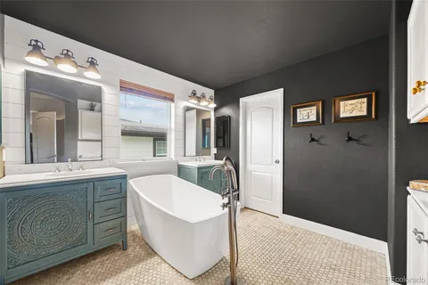 a spacious bathroom with a sink mirror and a bathtub