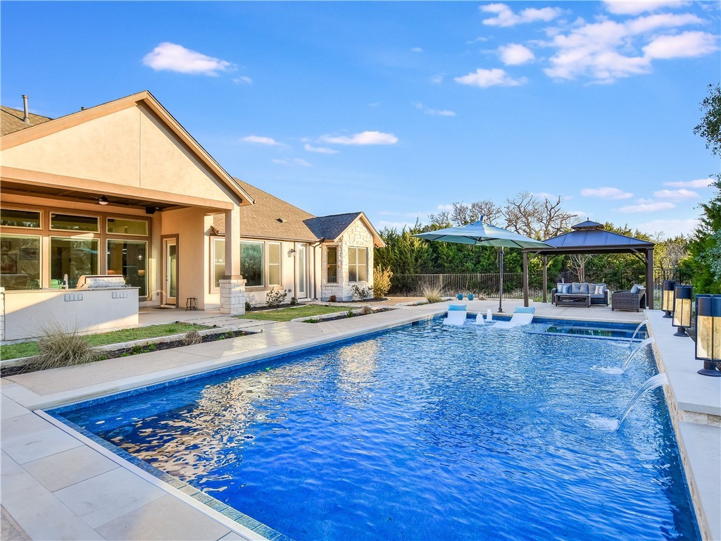 a view of a house with swimming pool and sitting area