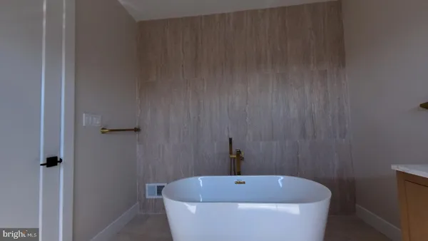 a white bath tub sitting in a bathroom