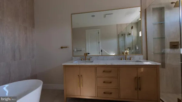 a bathroom with a granite countertop sink a toilet and a mirror
