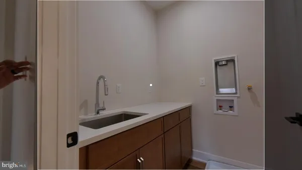 a close view of a sink and cabinets