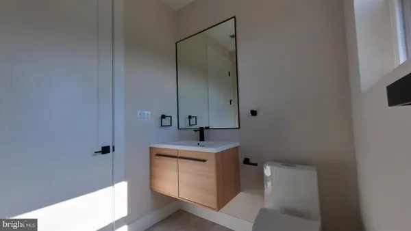 a bathroom with a sink toilet and mirror