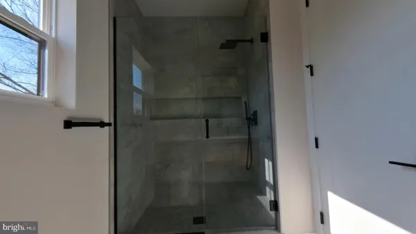a bathroom with a glass door shower