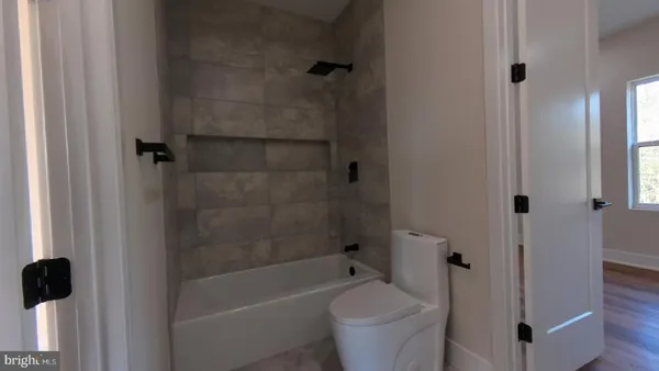 a bath room with a toilet and a bath tub
