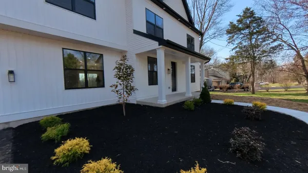 a front view of a house with a yard and outdoor seating