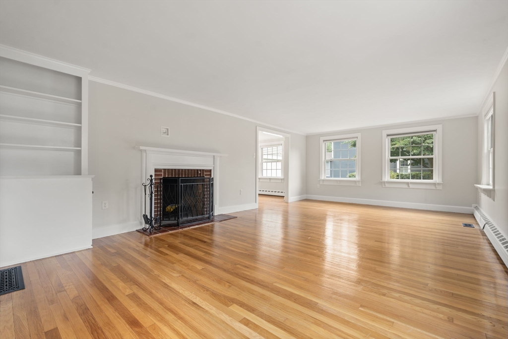 92 Abbot Street Andover, MA 01810 - Photo 12 of 35 an empty room with wooden floor and fireplace