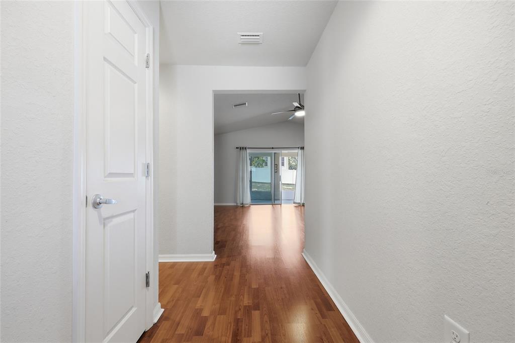 306 Stone Point Lane Lady Lake, FL 32159 - Photo 14 of 39 a view of a hallway with wooden floor