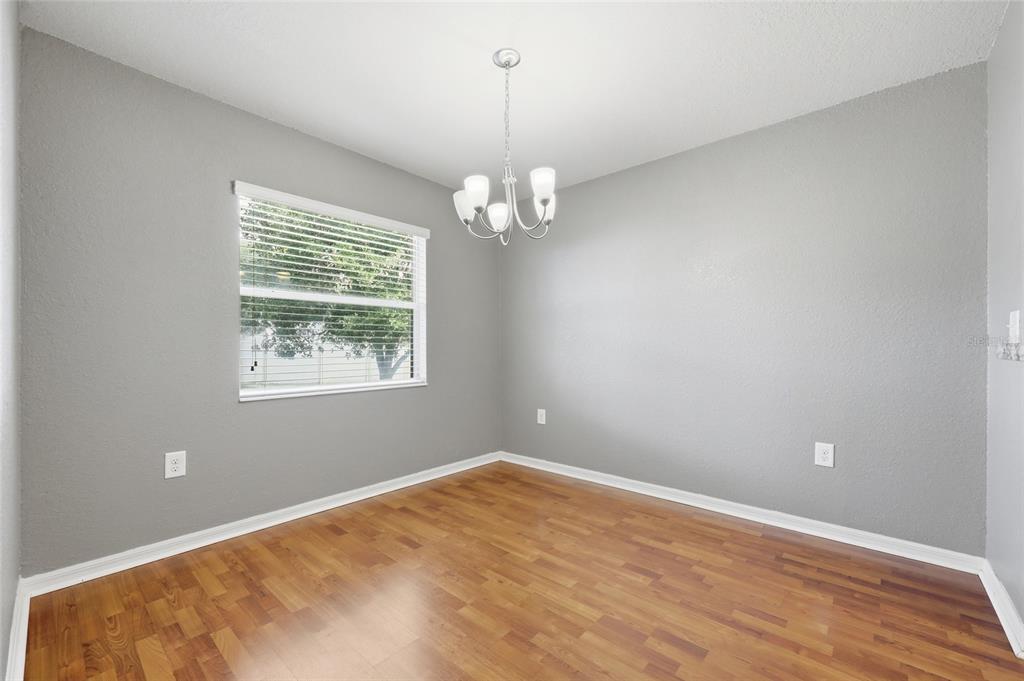 306 Stone Point Lane Lady Lake, FL 32159 - Photo 17 of 39 wooden floor in an empty room with a window