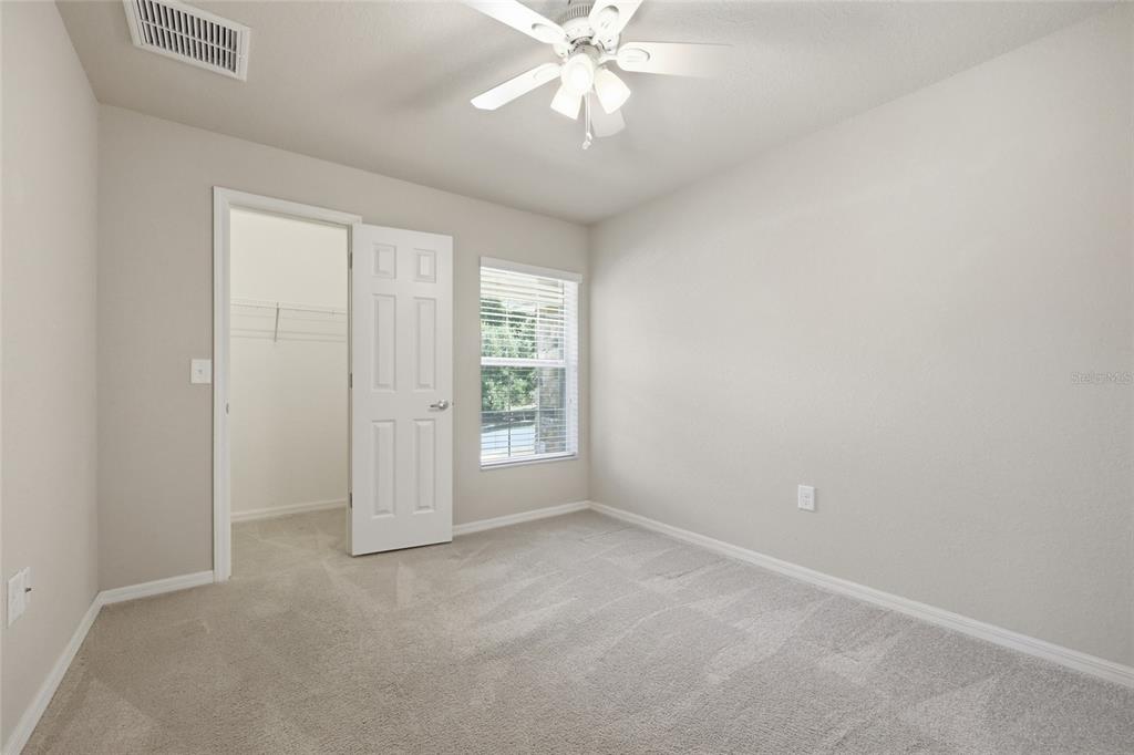 306 Stone Point Lane Lady Lake, FL 32159 - Photo 19 of 39 an empty room with windows and fan