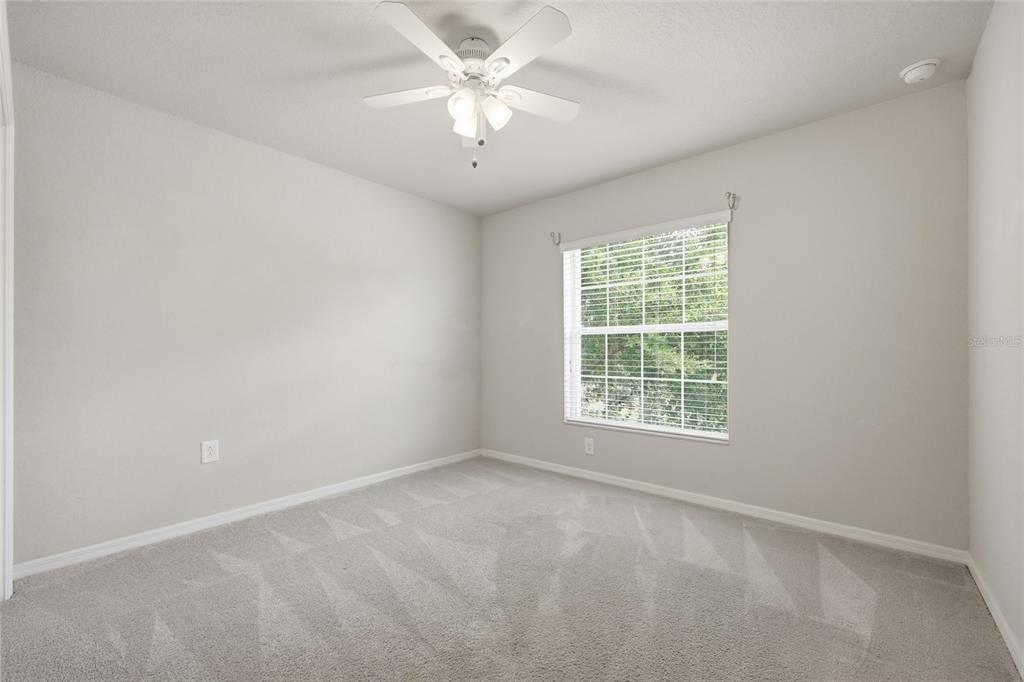 306 Stone Point Lane Lady Lake, FL 32159 - Photo 20 of 39 an empty room with a window and a fan
