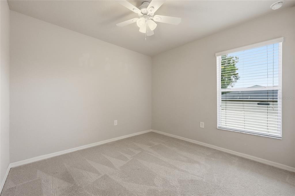306 Stone Point Lane Lady Lake, FL 32159 - Photo 21 of 39 an empty room with a window and a fan